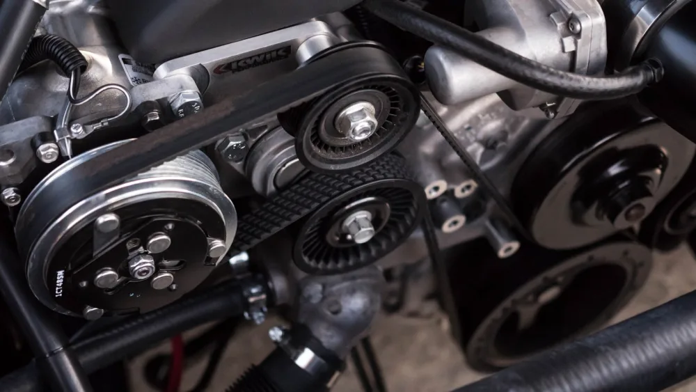 The serpentine belt that drives the A/C compressor