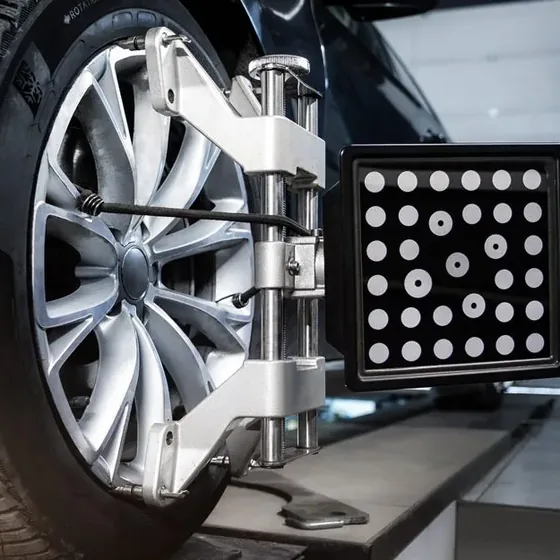 Optical alignment target clamped to a front wheel