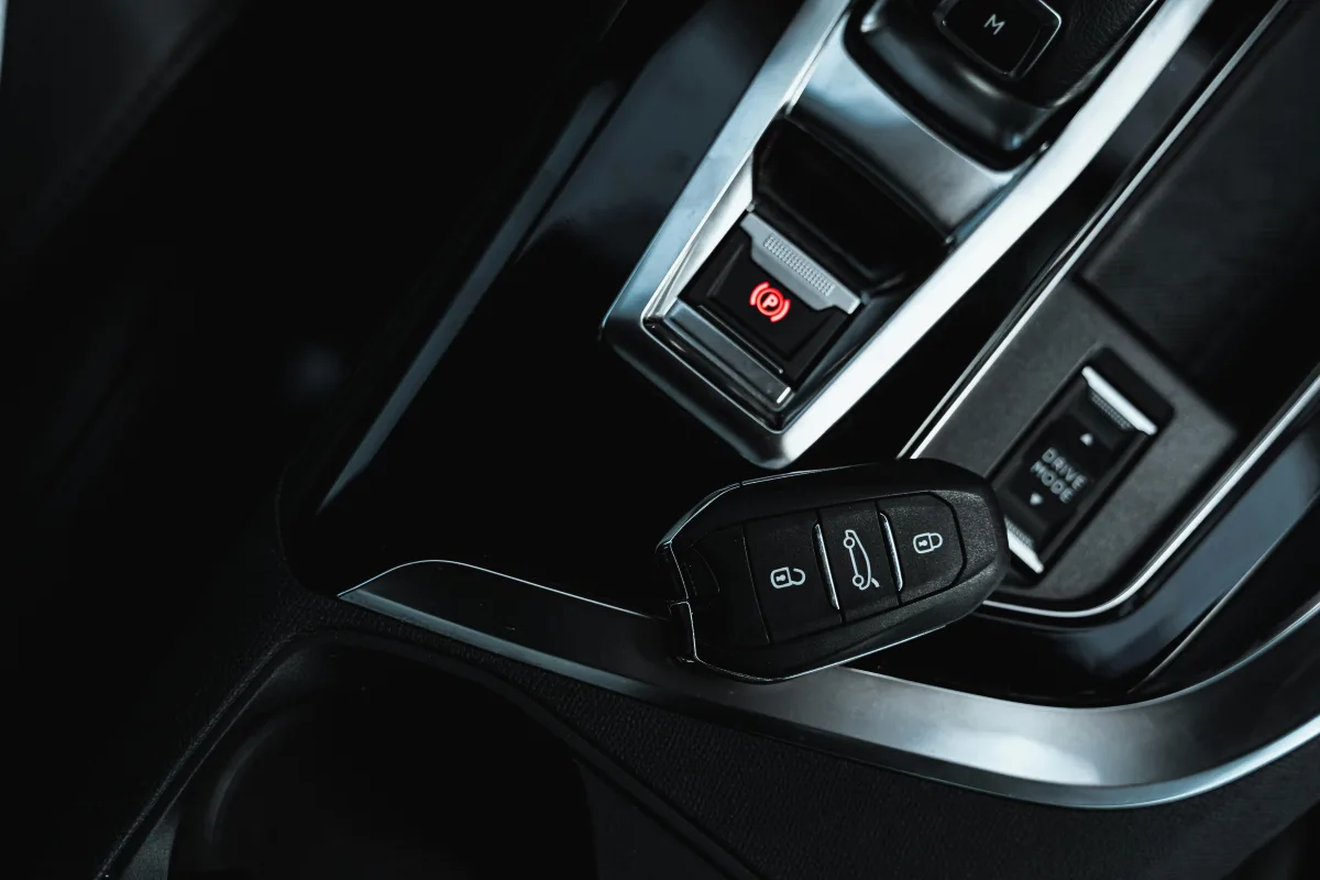 A key resting on a centre console beside its USB port