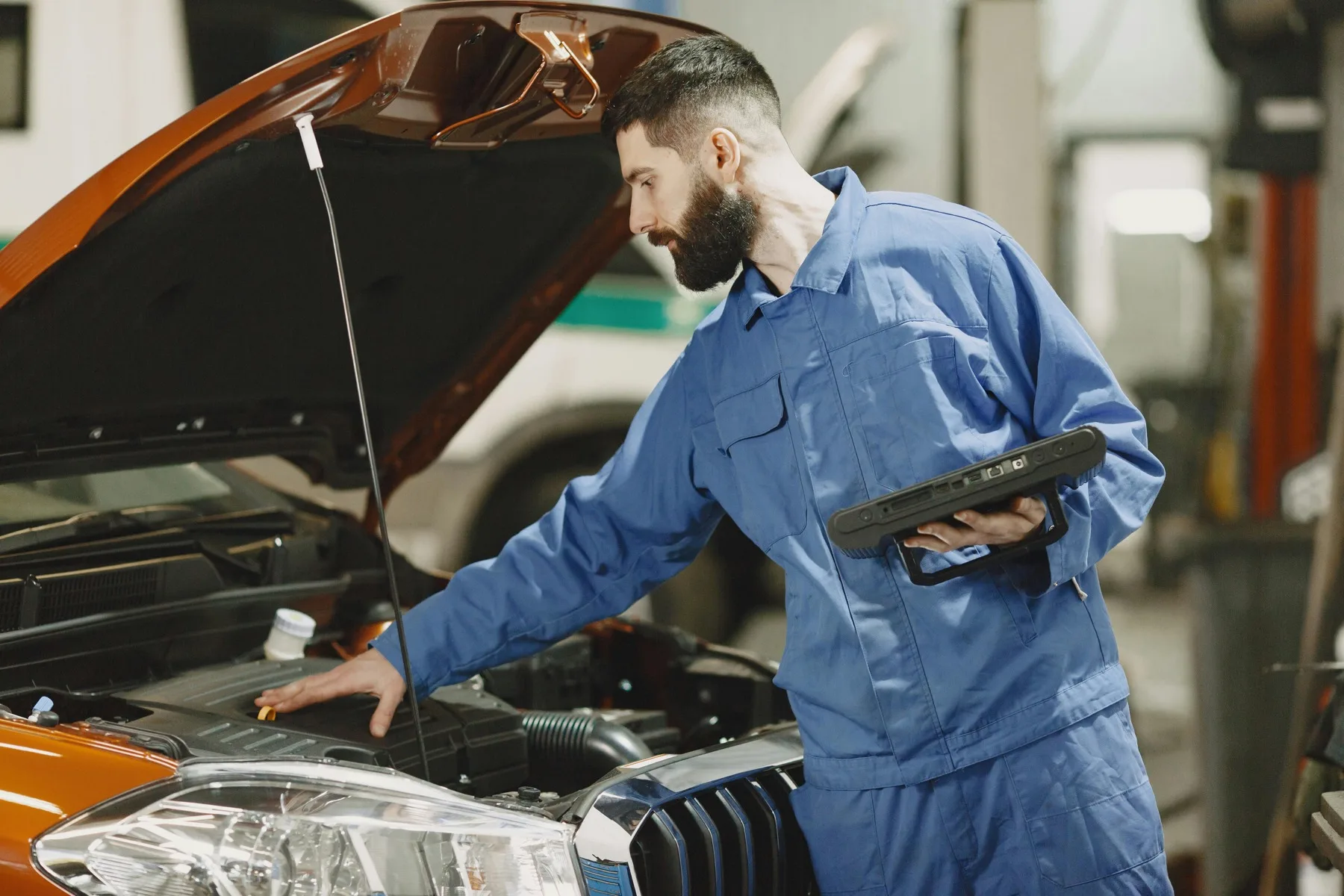 A technician working in an engine bay