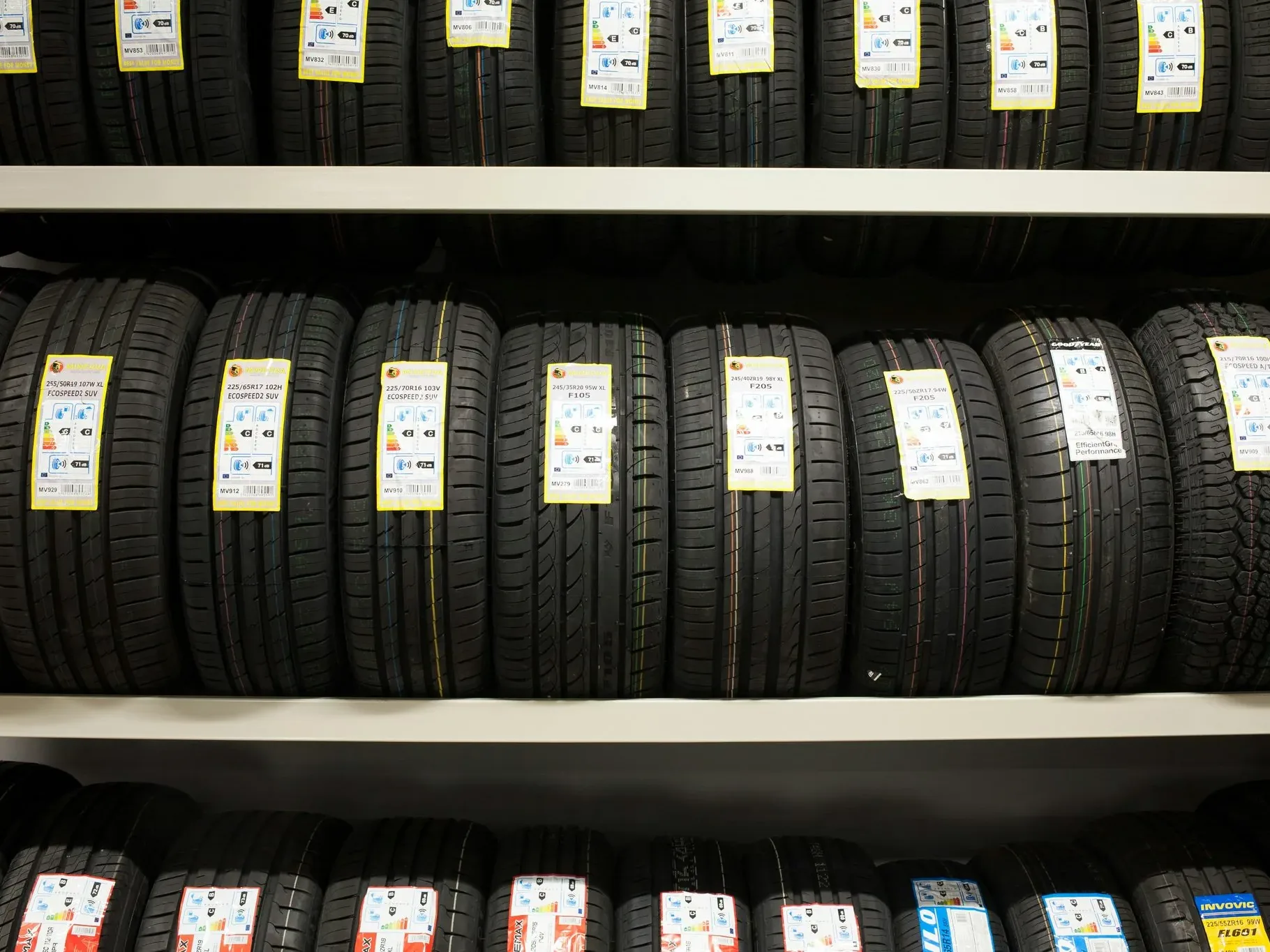 Tires stacked in rows on workshop shelving